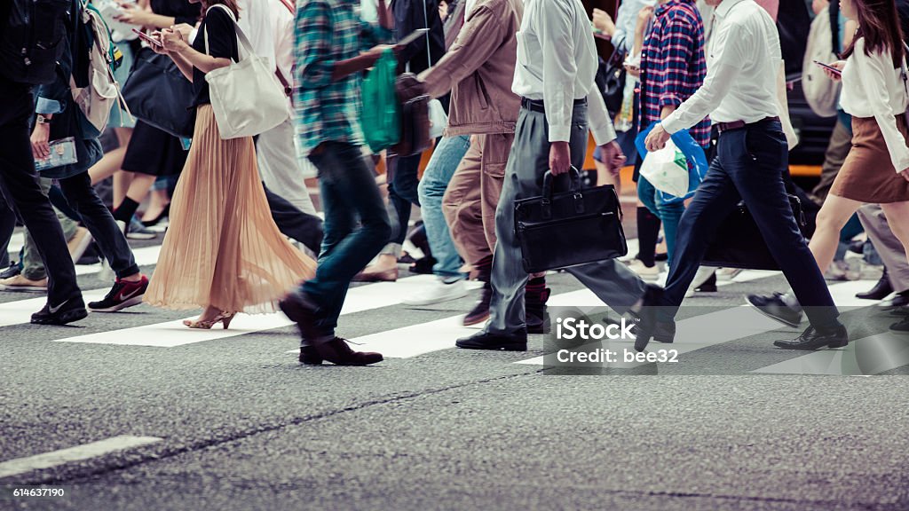 People crossing a busy city street.