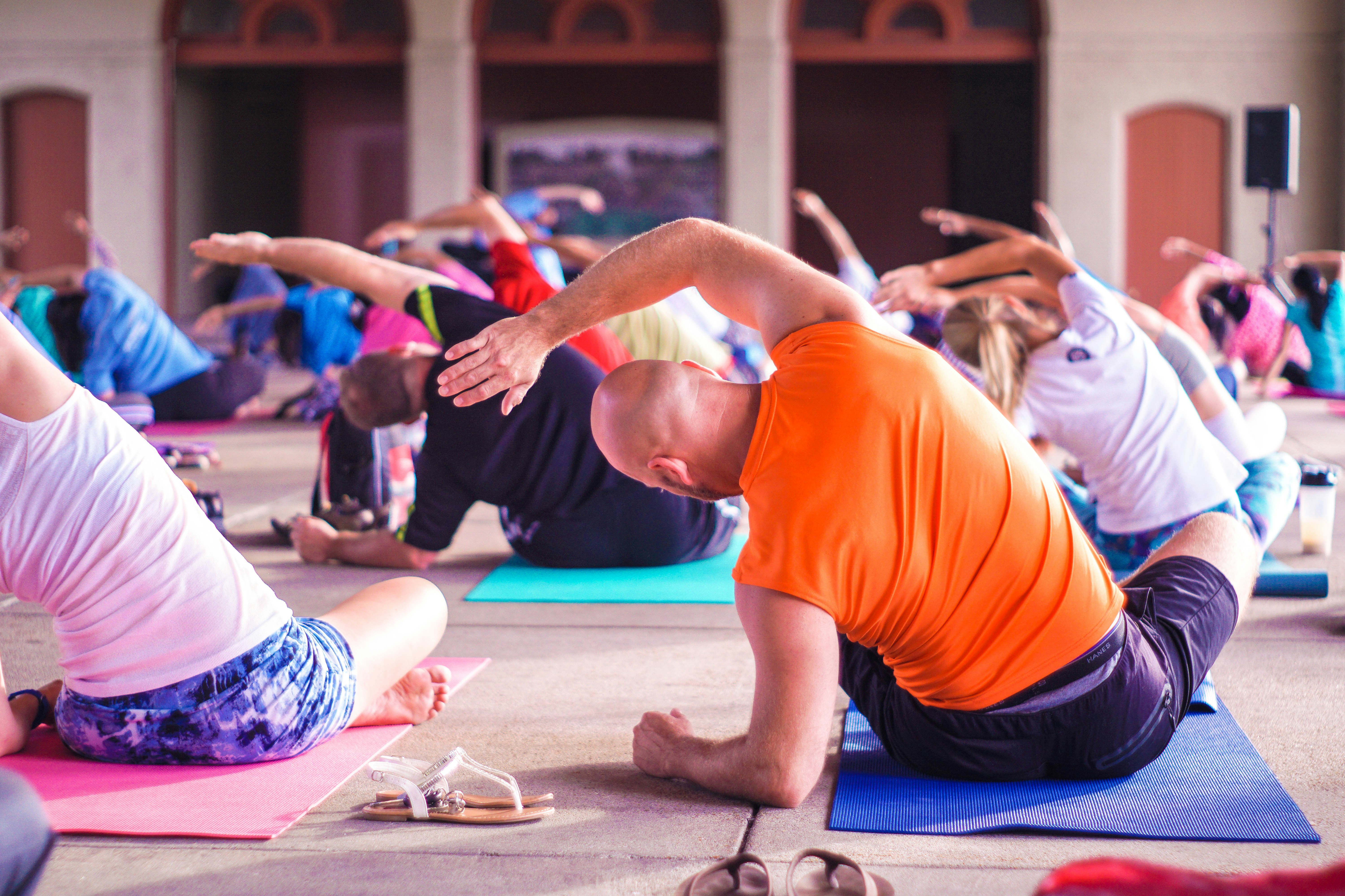 Group of people are doing yoga in the gym.