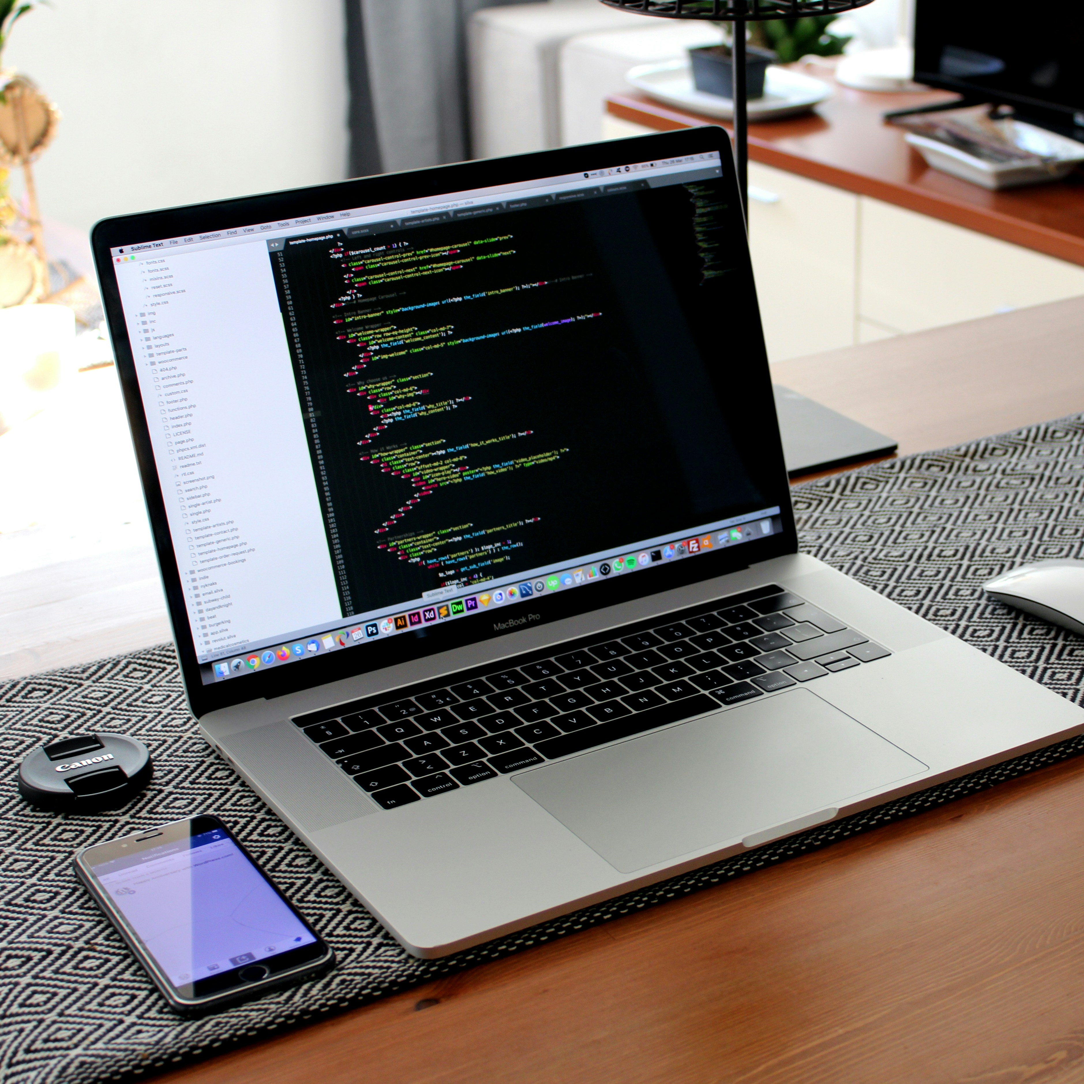 Laptop screen displaying web development code.